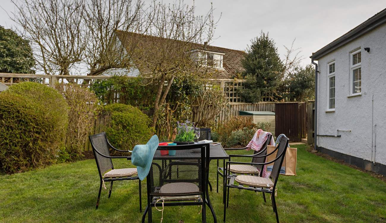 The garden is accessed via a secure gate from the shingle driveway.