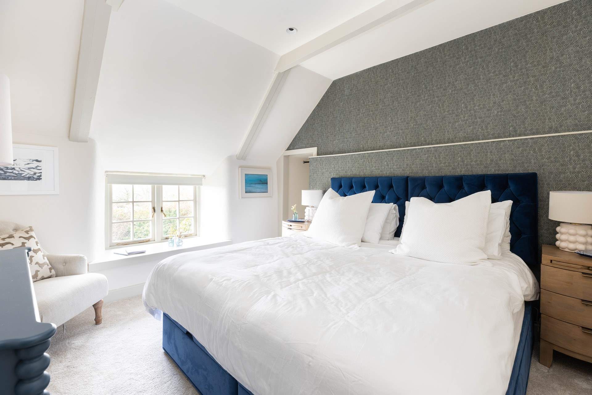 This bedroom (Fowey) has beautiful feather wallpaper and 'zip and link' beds. 