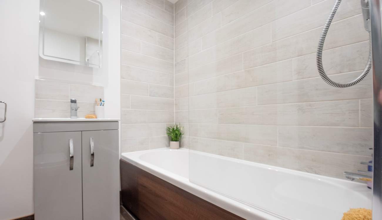 The family bathroom sits between bedroom 3 and 4 on the lower ground floor.