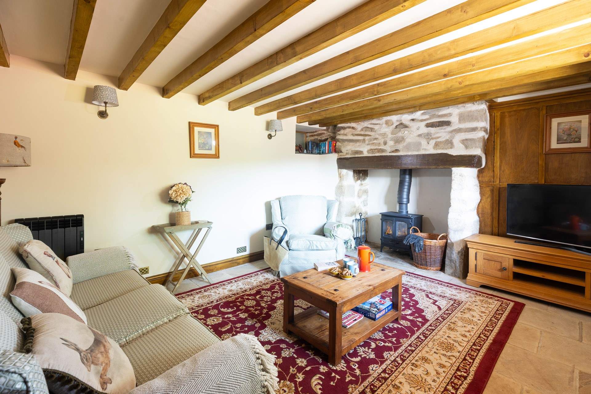 The snug sitting-room with warming wood-burner. 