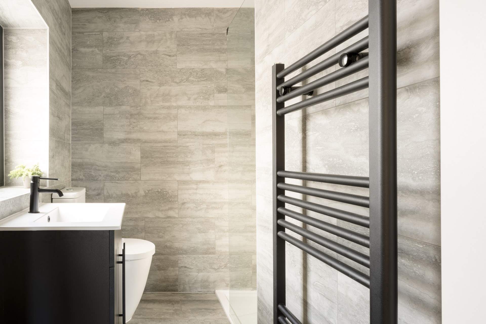 A stylish en suite shower-room with heated towel rail.