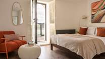Bedroom 2 has direct access to the shared balcony.