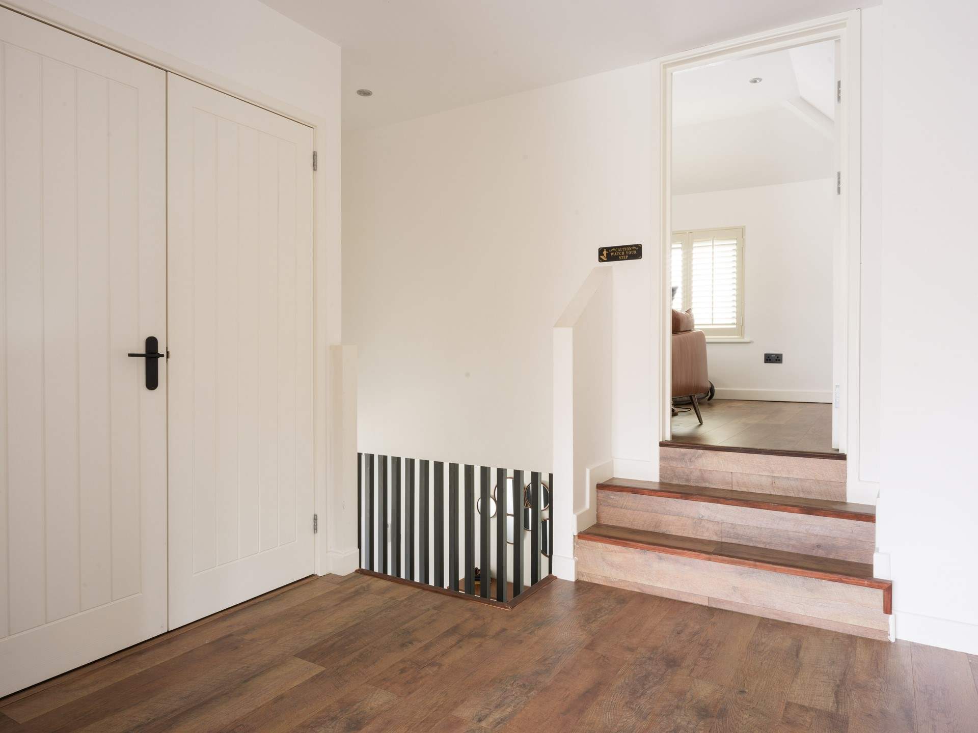 Head up to the open plan living area or downstairs to the bedrooms.