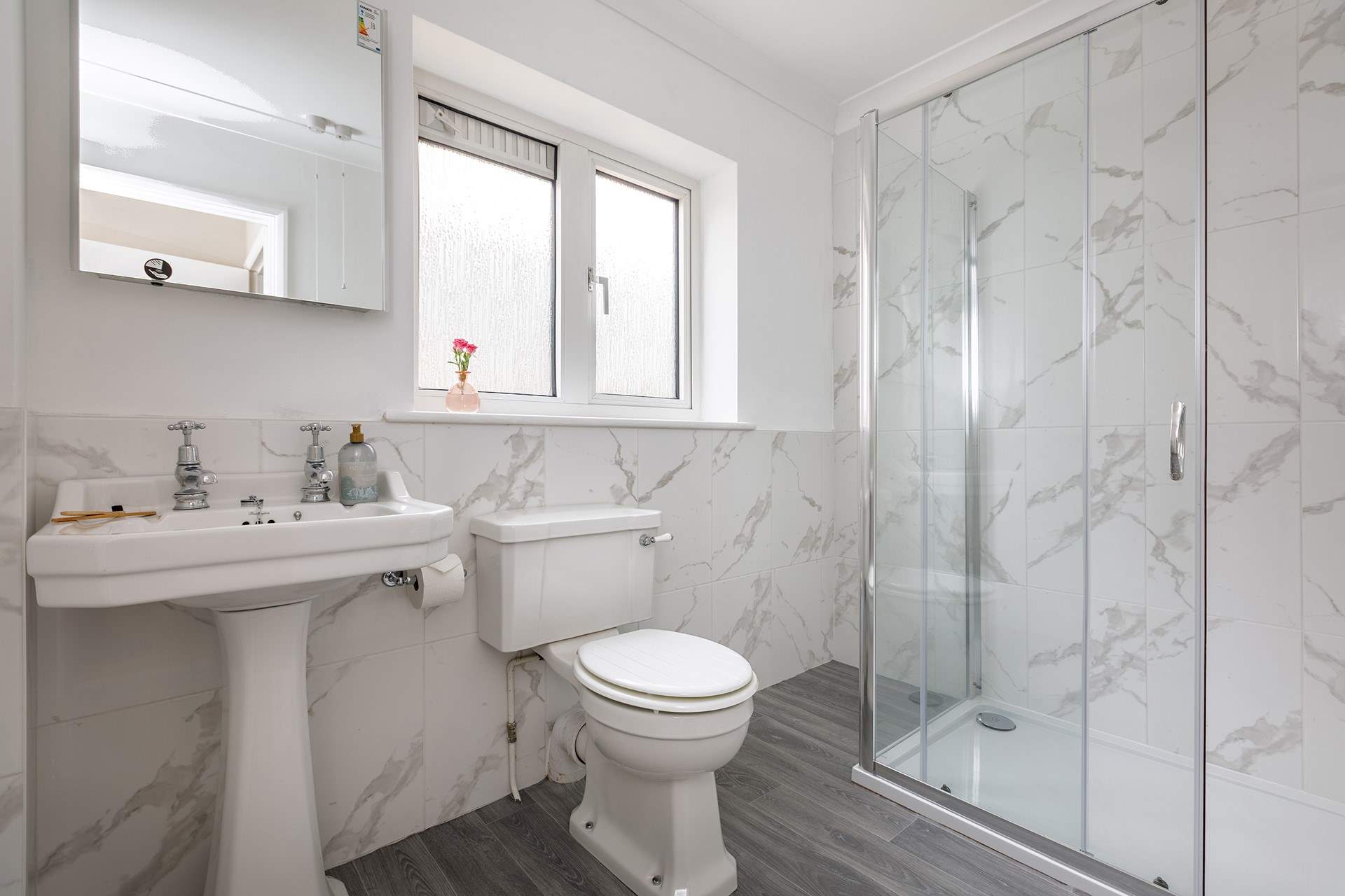 A spacious shower is perfect after a day at the local beach, a five minute stroll away.