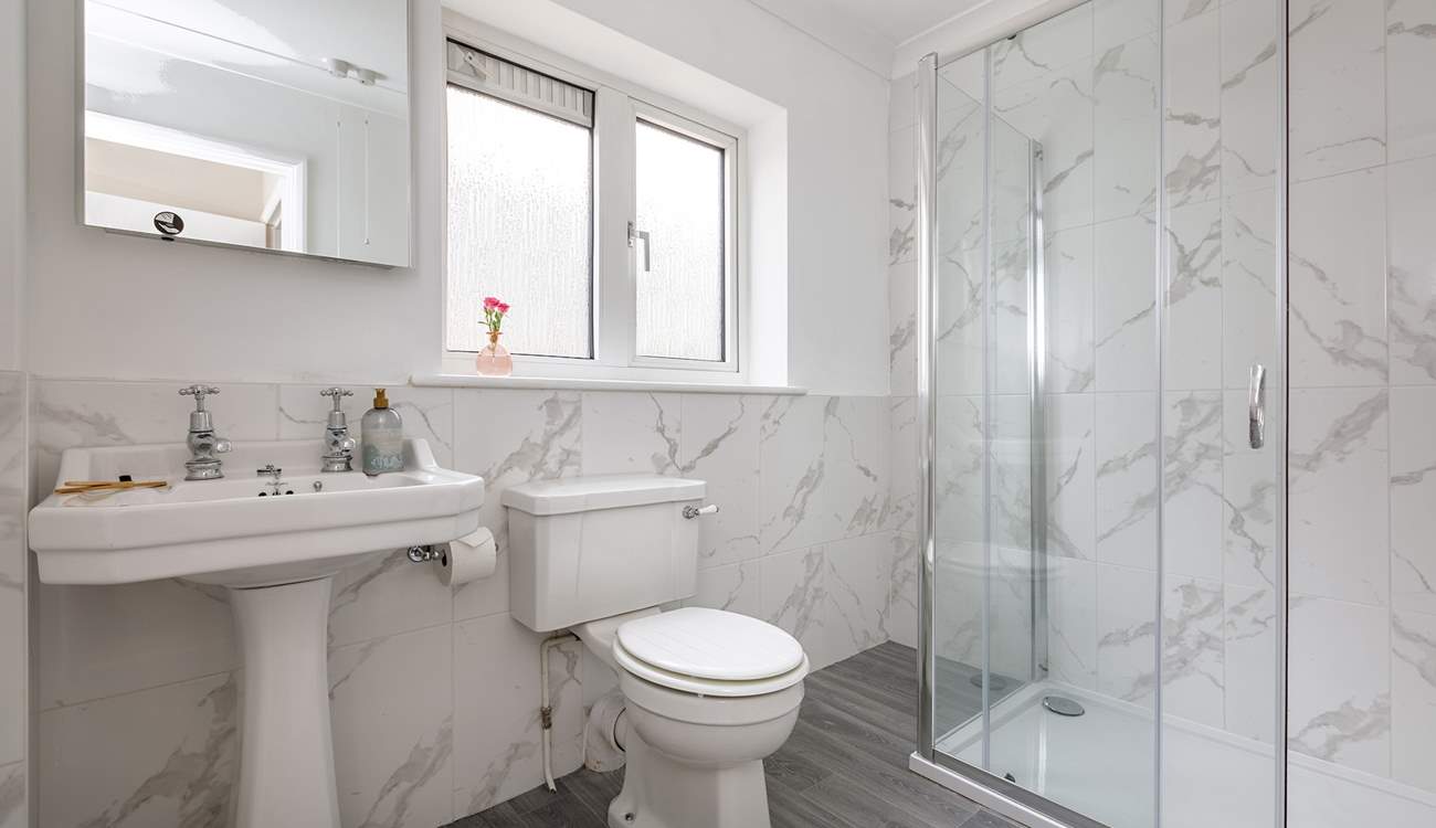 A spacious shower is perfect after a day at the local beach, a five minute stroll away.