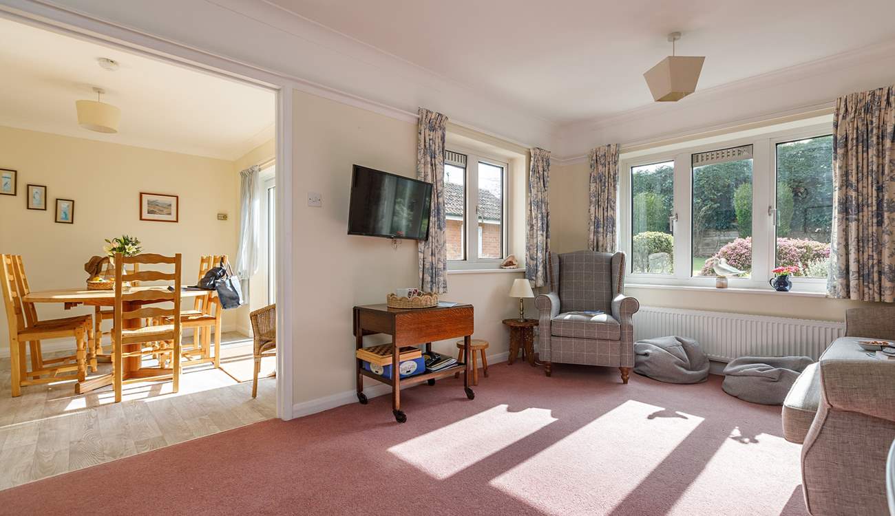 The light floods into the sitting and dining space.