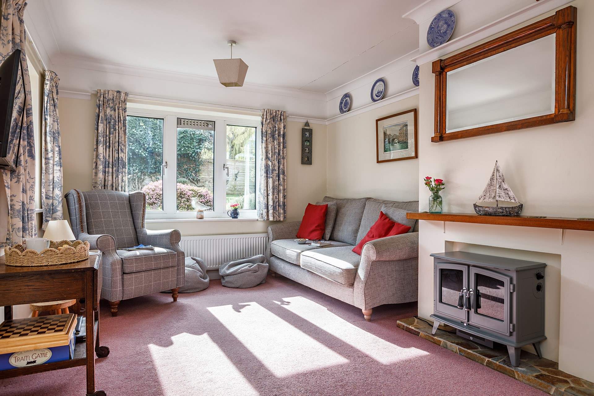 The light filled sitting-room is dual-aspect with views into the garden and open to the dining-room.