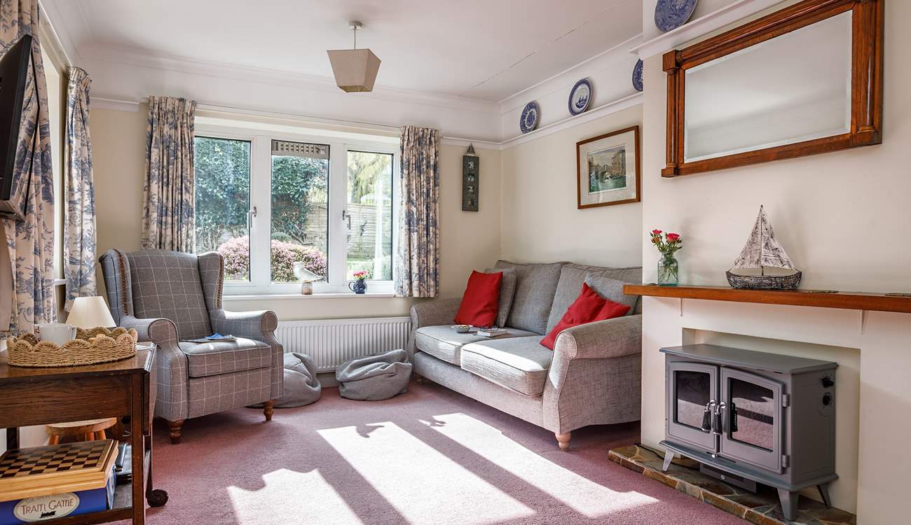The light filled sitting-room is dual-aspect with views into the garden and open to the dining-room.