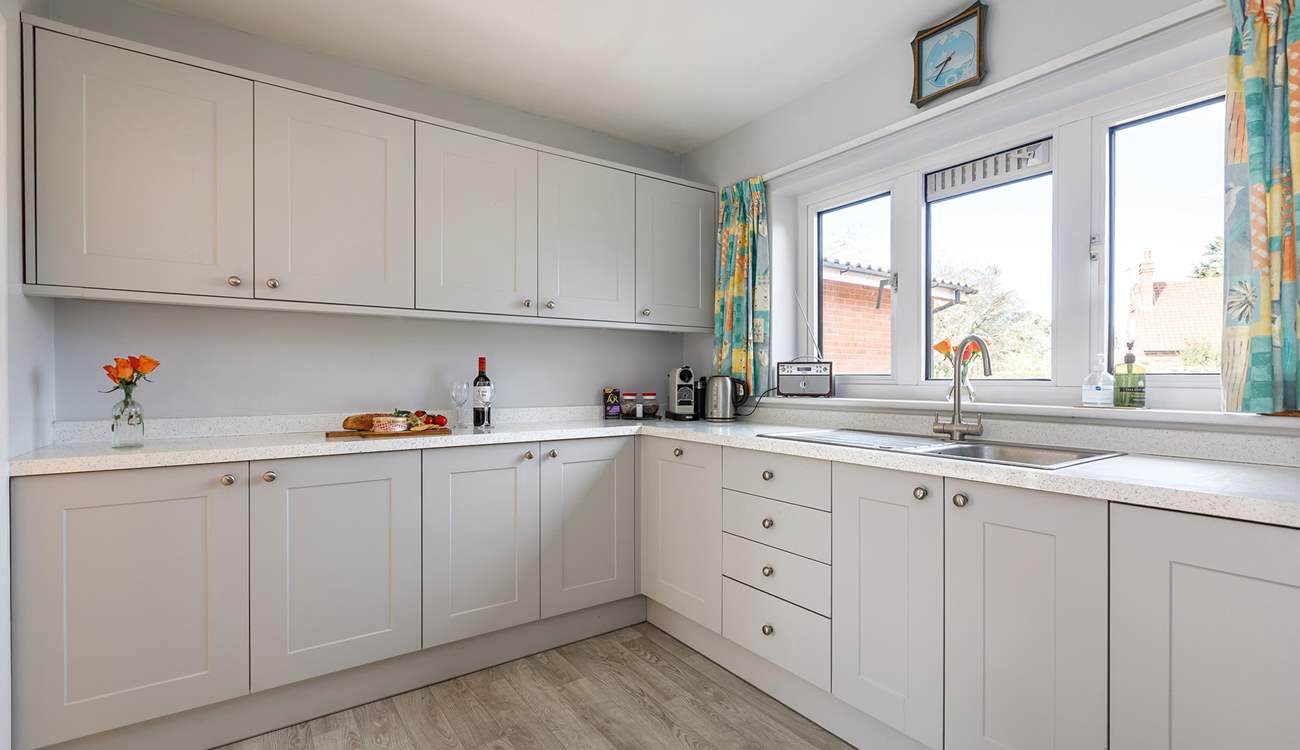 The spacious kitchen is accessed from the dining-room with plenty of amenities and a handy utility-room next door.