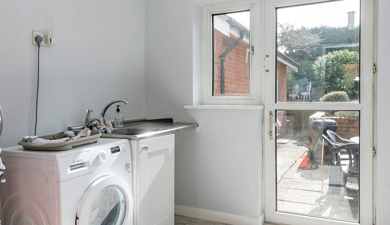 The large utility-room is ideal for sandy shoes and coats on cooler days complete with washing machine.