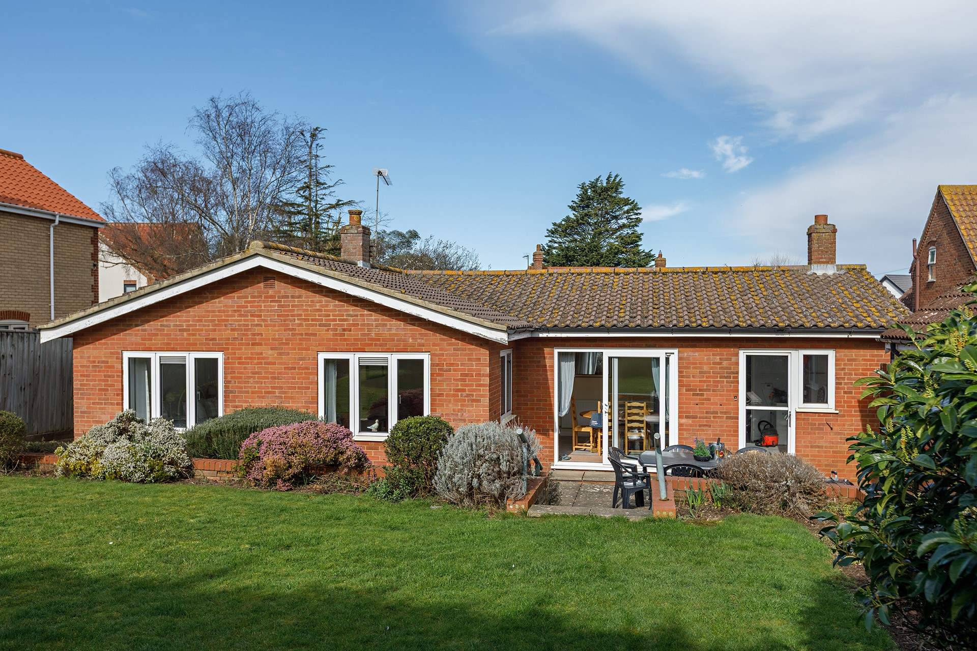 Dine out on the patio with friends in this roomy garden with steps leading to the raised lawn with a westerly aspect.