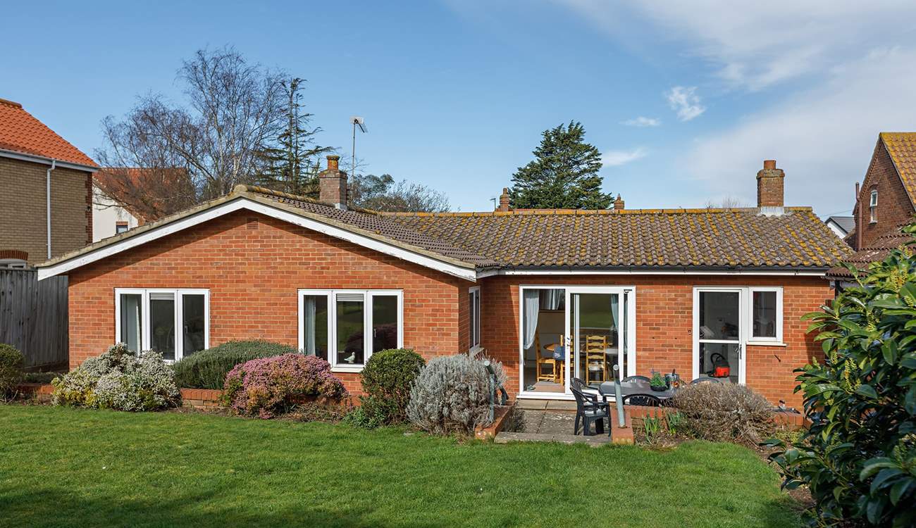 Dine out on the patio with friends in this roomy garden with steps leading to the raised lawn with a westerly aspect.