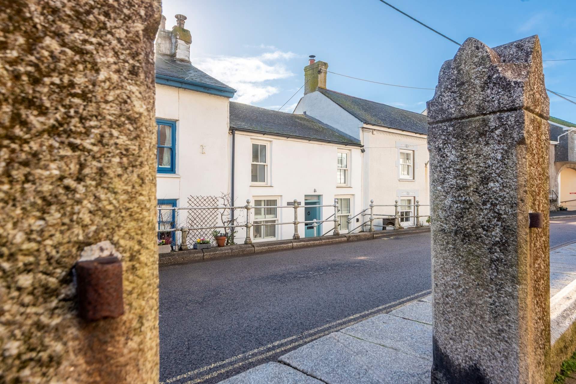 The cottage is set slightly back from the road down three ancient granite steps opposite the Methodist Church. Private parking for one car is at the side of the neighbouring property.