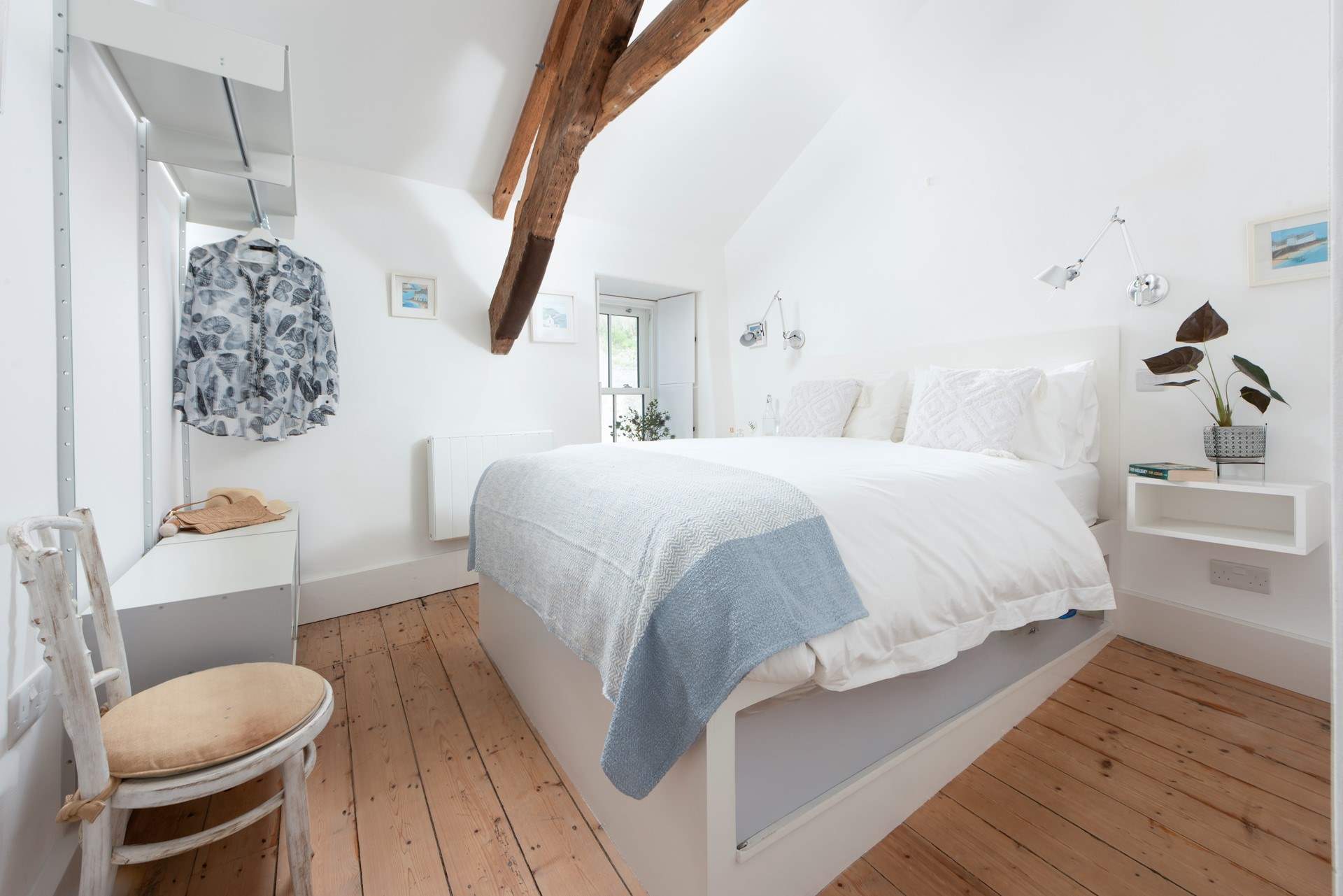 Bedroom 1 boasts a luxurious king-size bed with a sweet window seat. Mind your head on the beam.