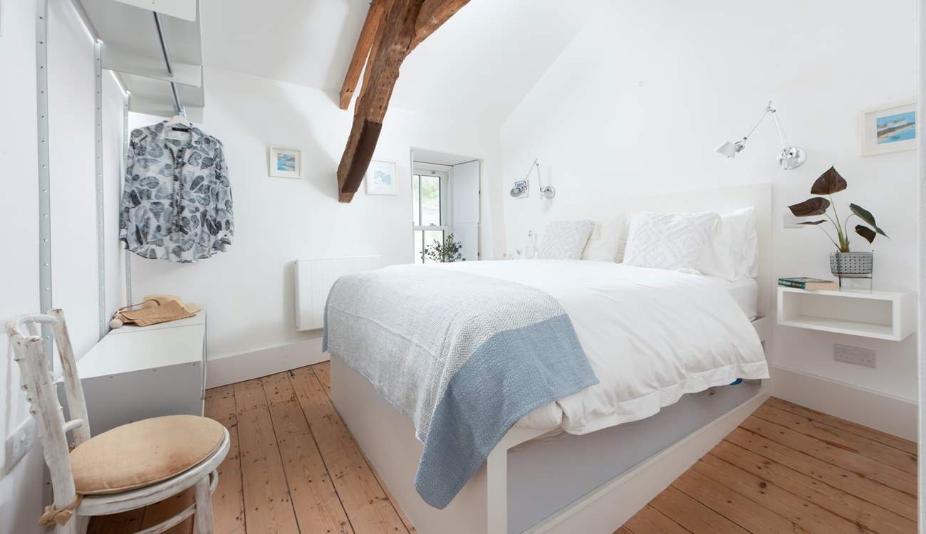 Bedroom 1 boasts a luxurious king-size bed with a sweet window seat. Mind your head on the beam.