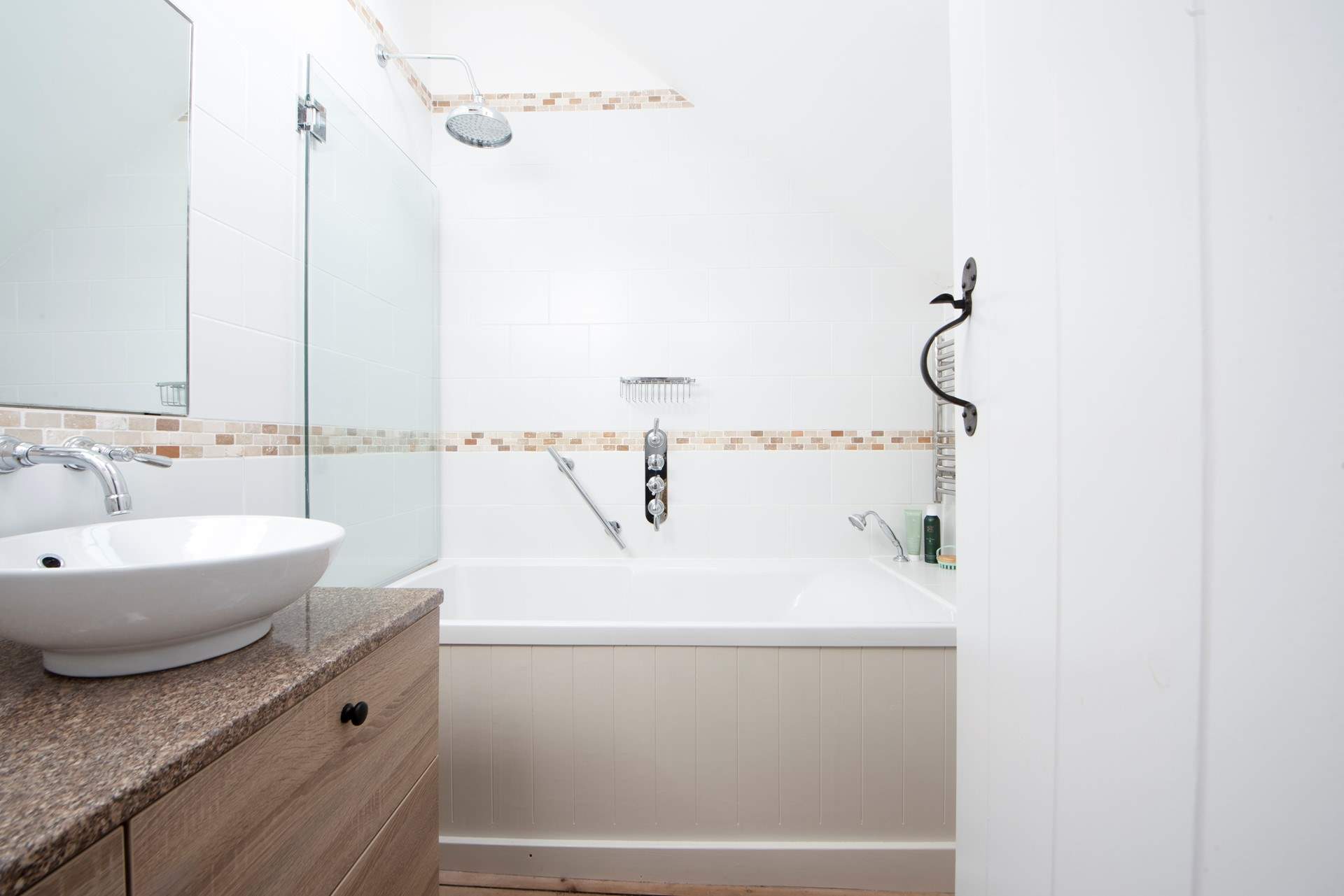 A spacious modern bathroom with rainfall shower.