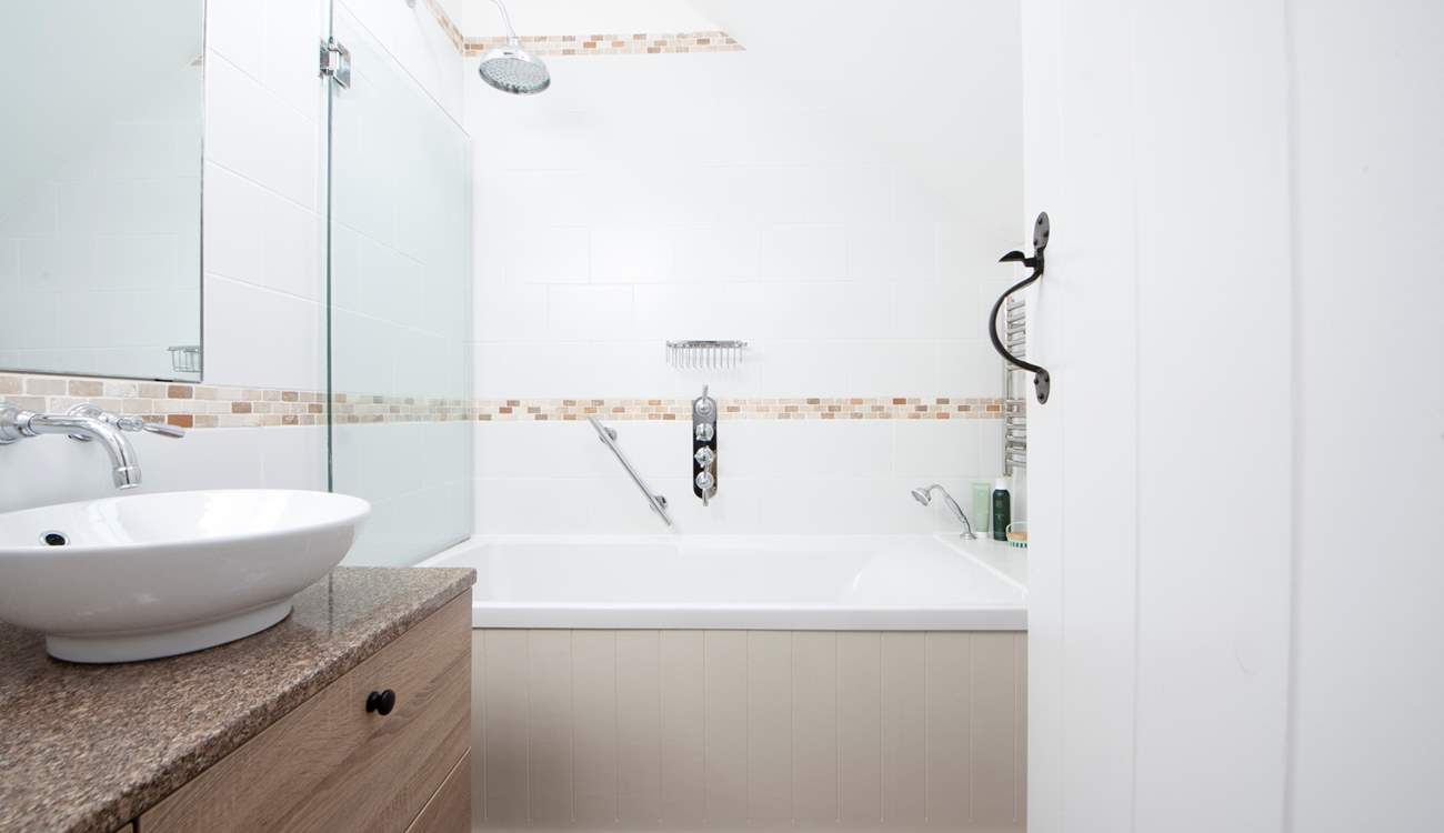 A spacious modern bathroom with rainfall shower.