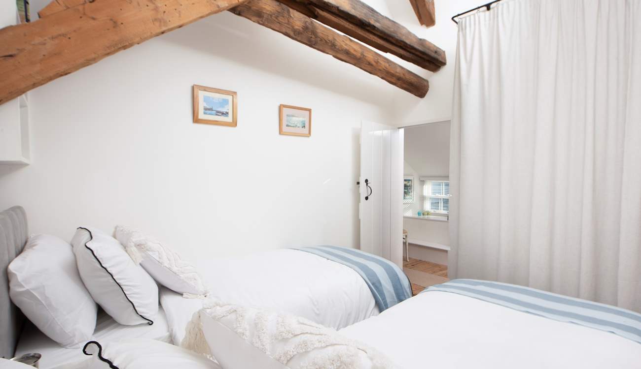 Appreciate the ancient structure of this historic house, the beams run through the entire property. Plenty of hanging space behind the curtain.