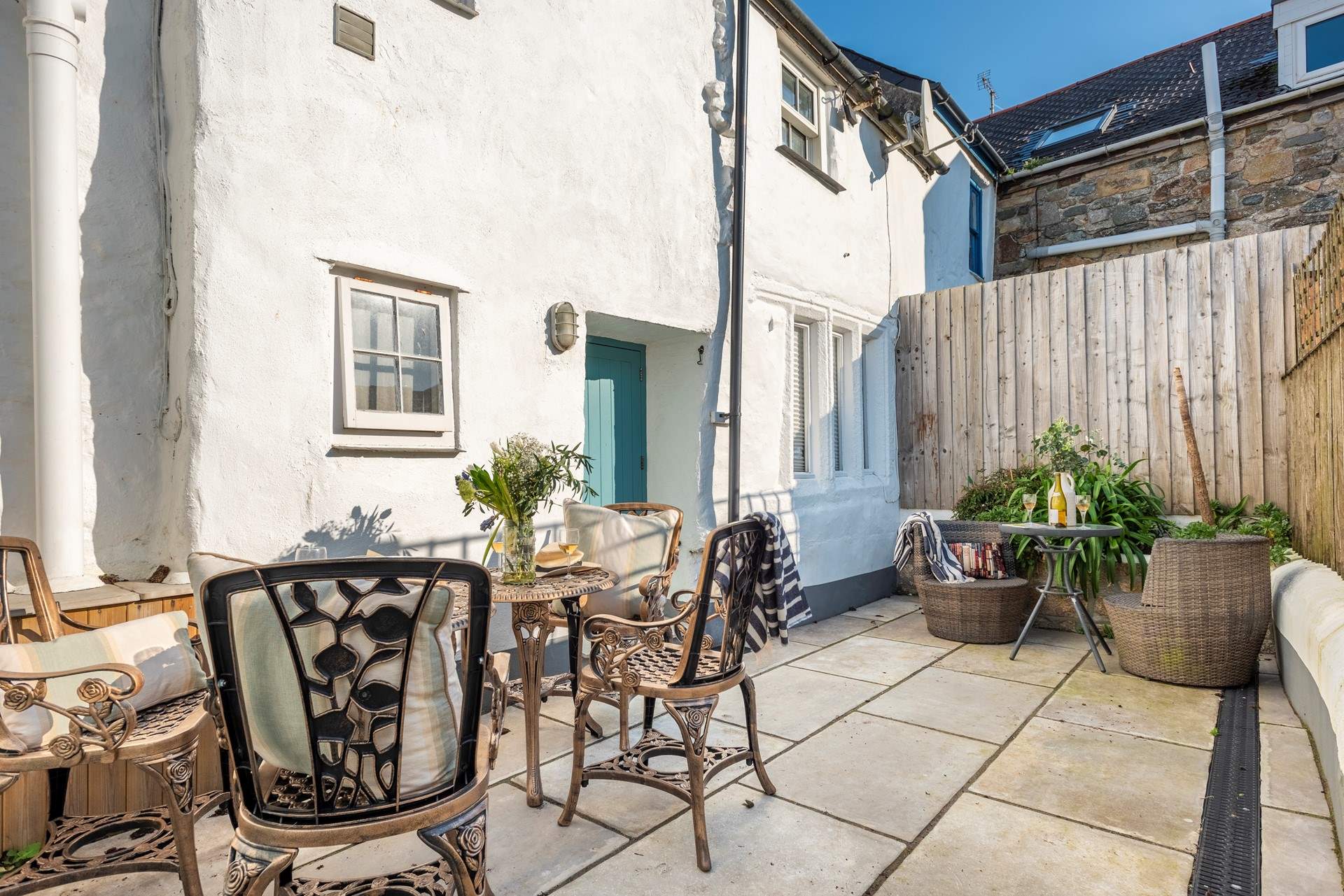 A sweet courtyard at the rear of the cottage is perfect for outdoor dining, you can hear the sea just behind you.
