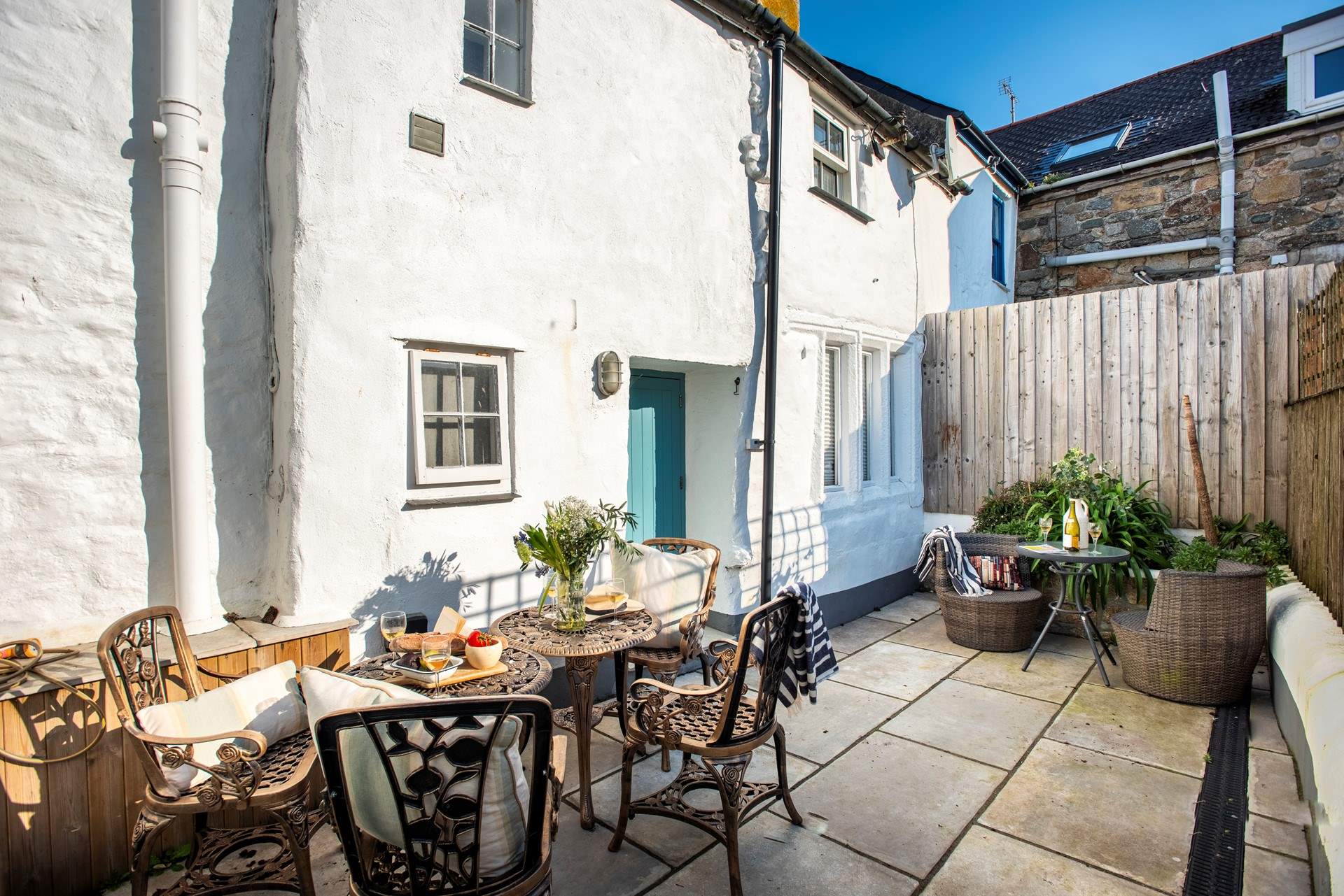 A sweet courtyard at the rear of the cottage is perfect for outdoor dining, you can hear the sea just behind you.