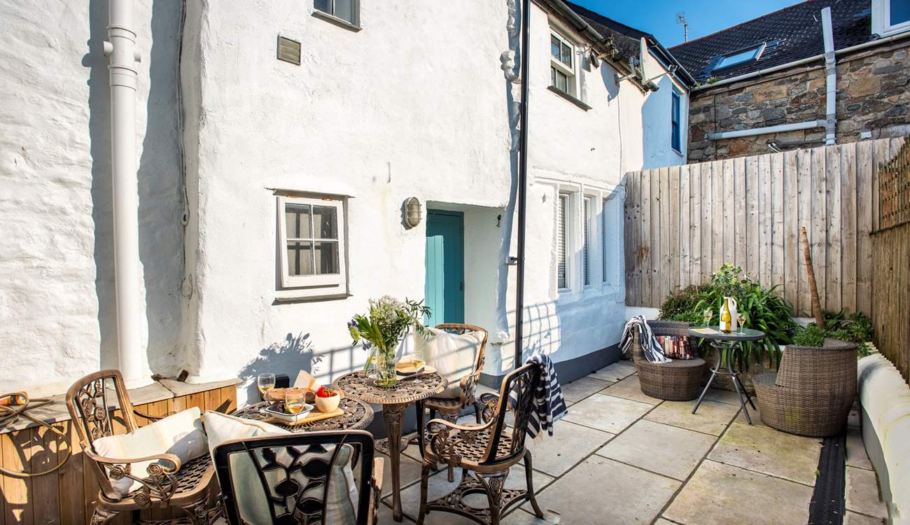 A sweet courtyard at the rear of the cottage is perfect for outdoor dining, you can hear the sea just behind you.