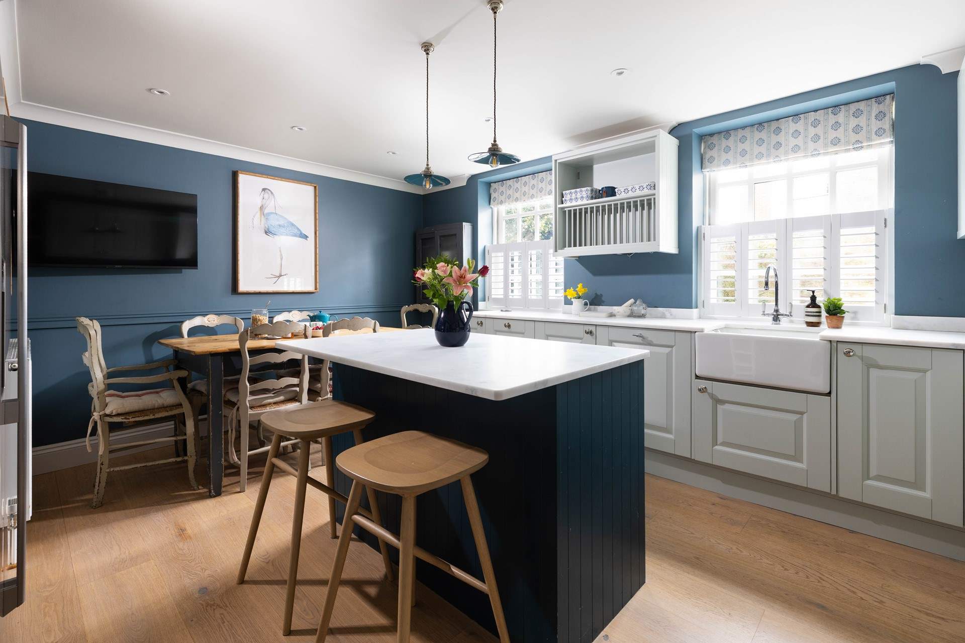 The lovely kitchen/breakfast-room has a sociable island and breakfast table, and a handy TV too. 