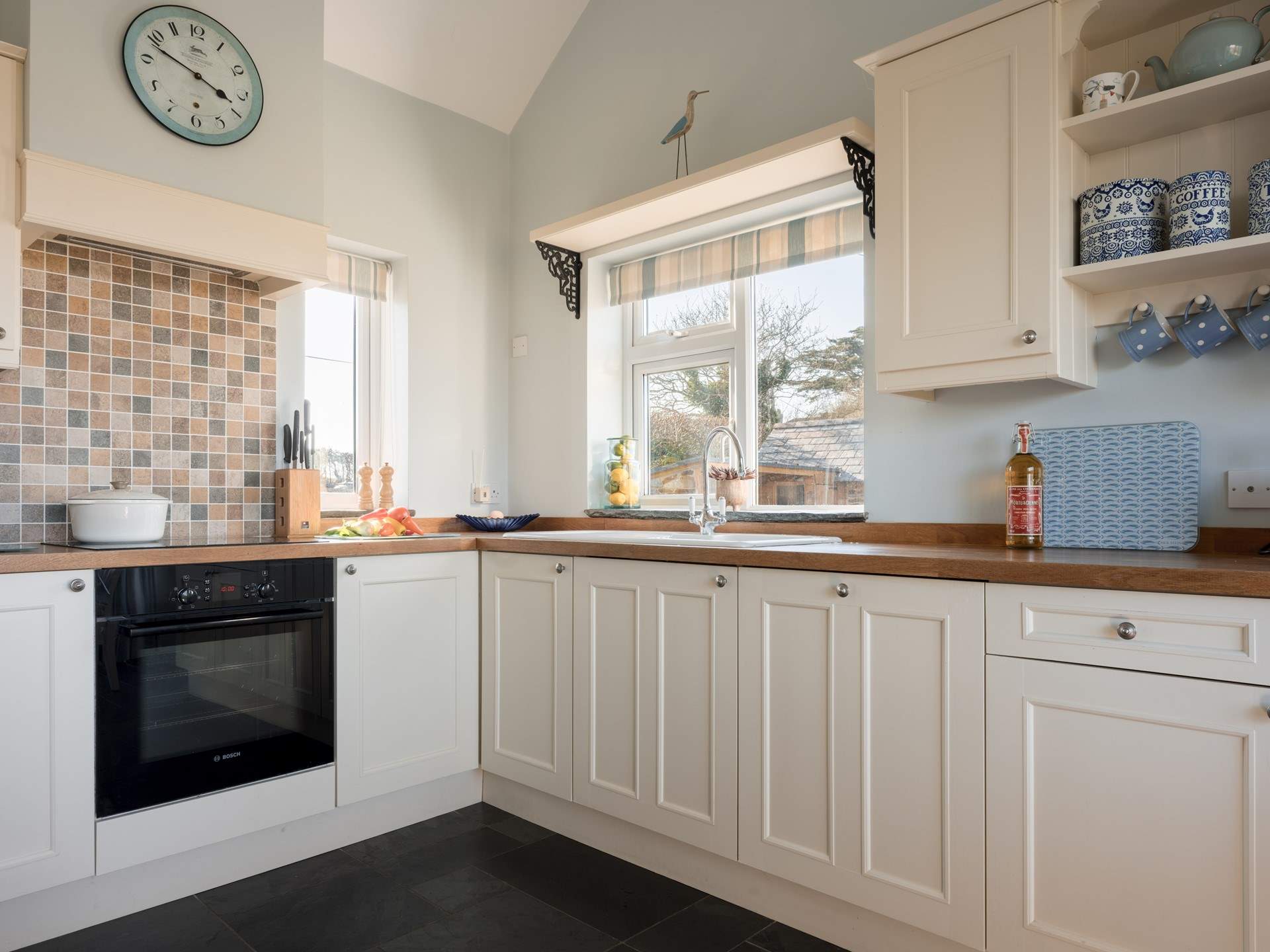 The gorgeous kitchen, with a vaulted ceiling, floods with light.
