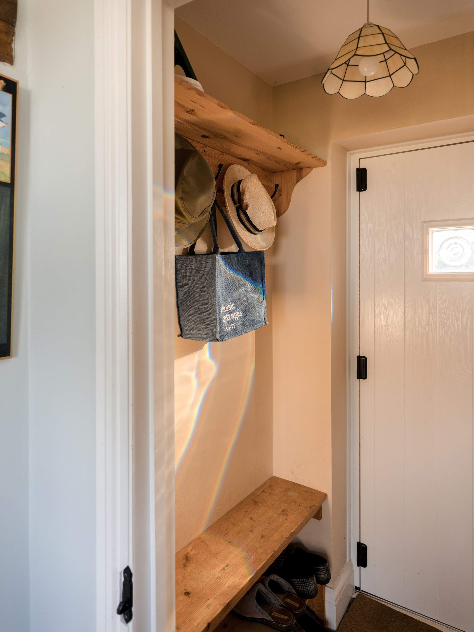 The bijou entrance hall where you will find the utility-cupboard.