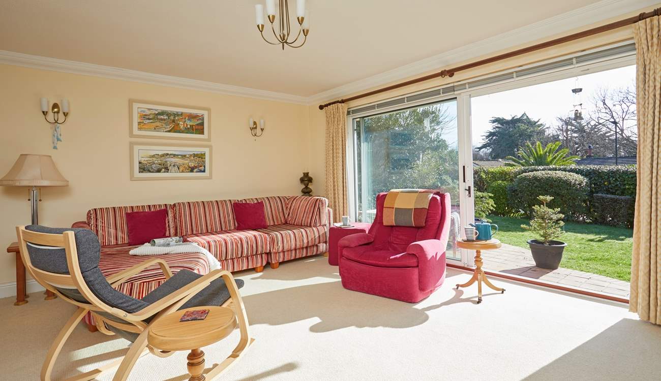 The sitting/dining-room is bright and airy.