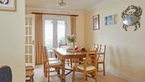 There are patio doors in both the sitting and dining areas, offering easy access to the pretty outside space.