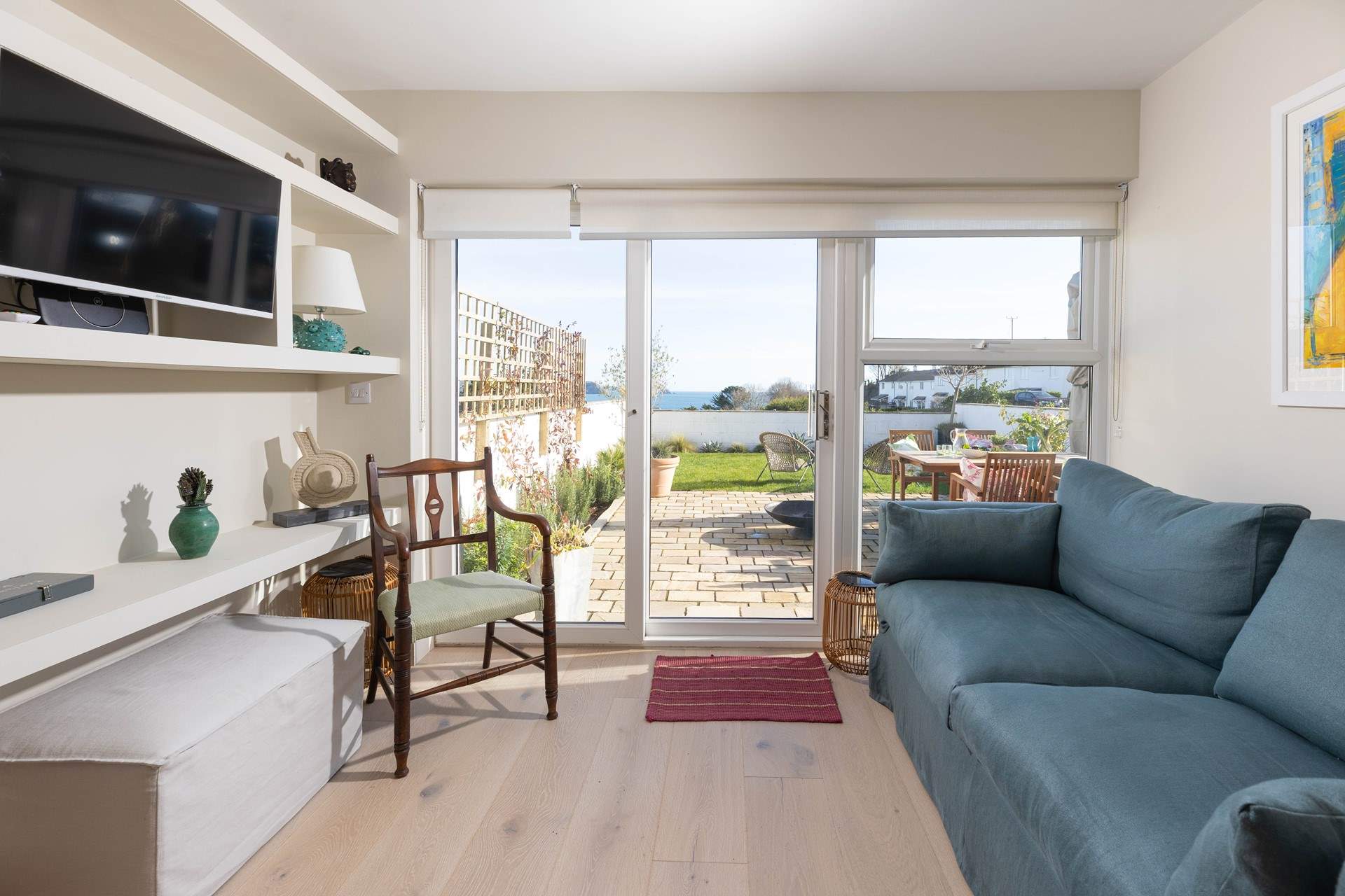 The spacious sitting-room is on the lower ground floor with access to the patio and garden. 