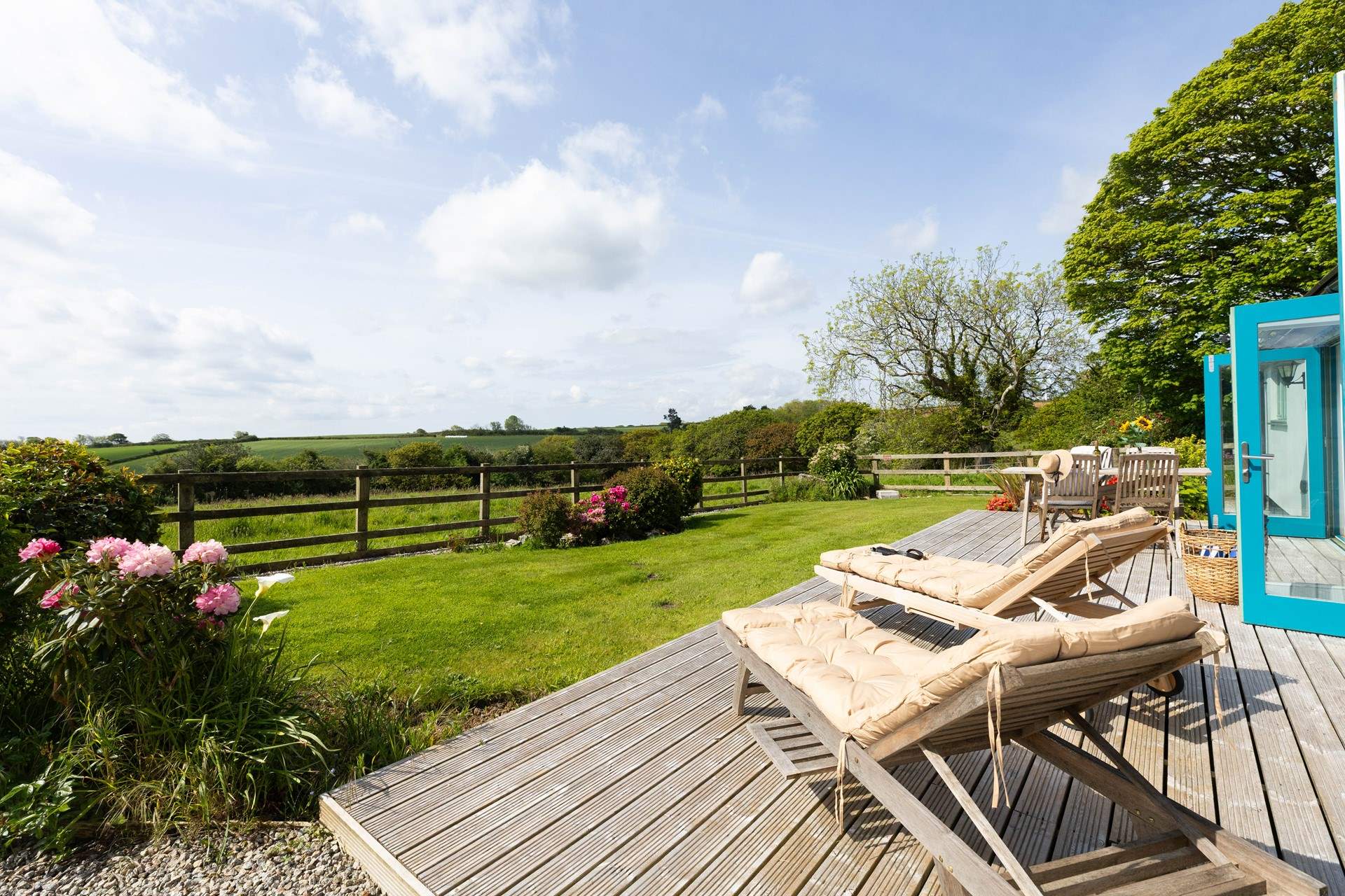 Enjoy relaxing on the sun loungers in this suntrap of a garden. 