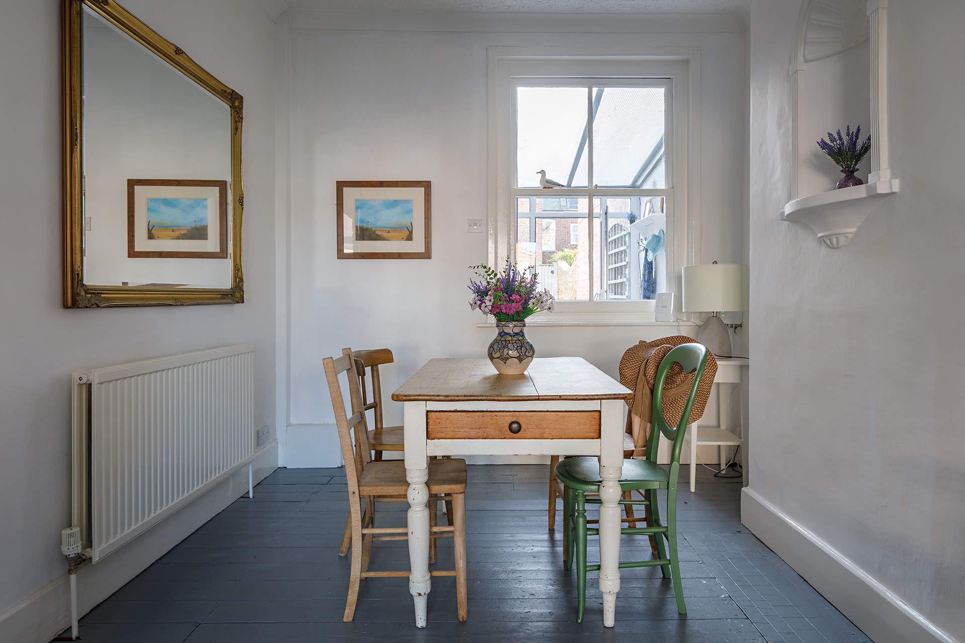 The dining-area, with a gorgeous garden-room beyond the window.