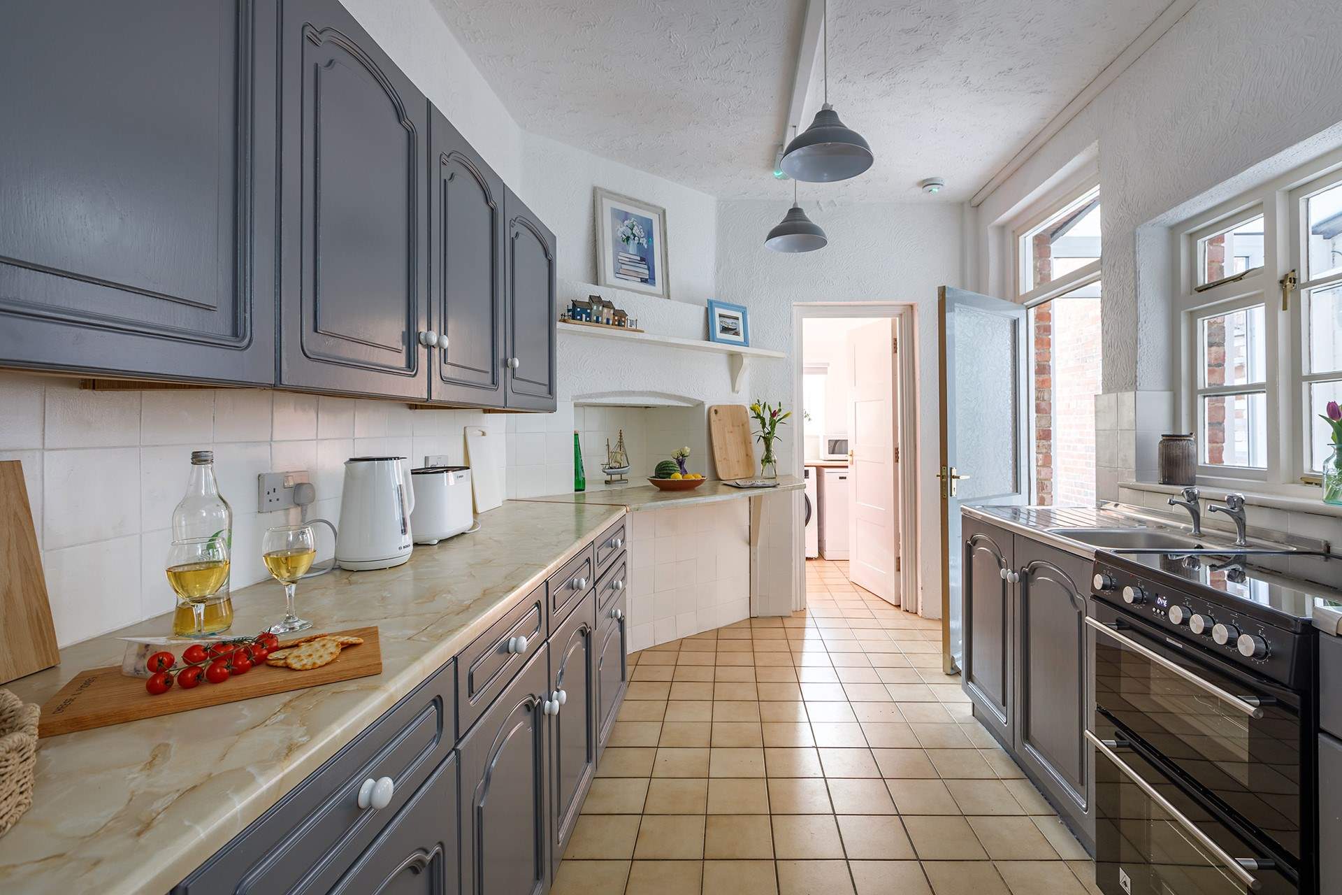 A practical and stylish space which leads to the utility-room and garden-room. 