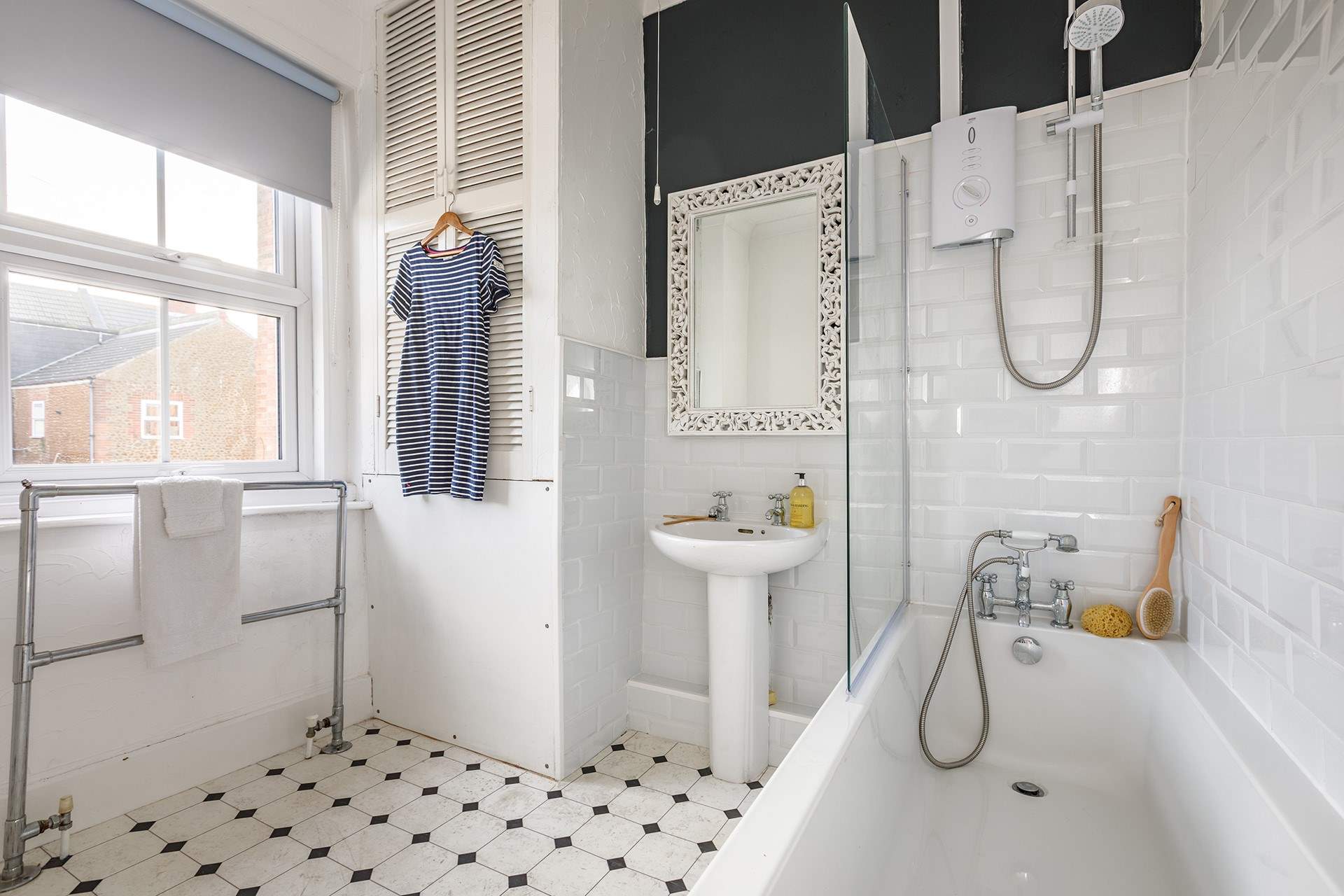 The spacious family bathroom has a shower over the bath.
