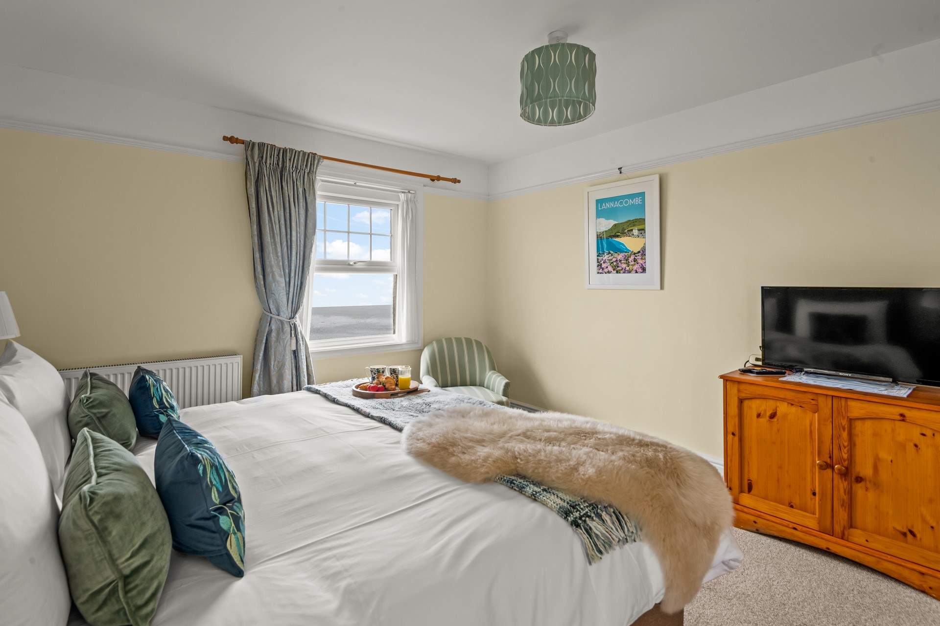 Bedroom 1 enjoys sea views and a TV for those lazy mornings.