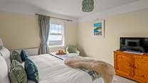 Bedroom 1 enjoys sea views and a TV for those lazy mornings.