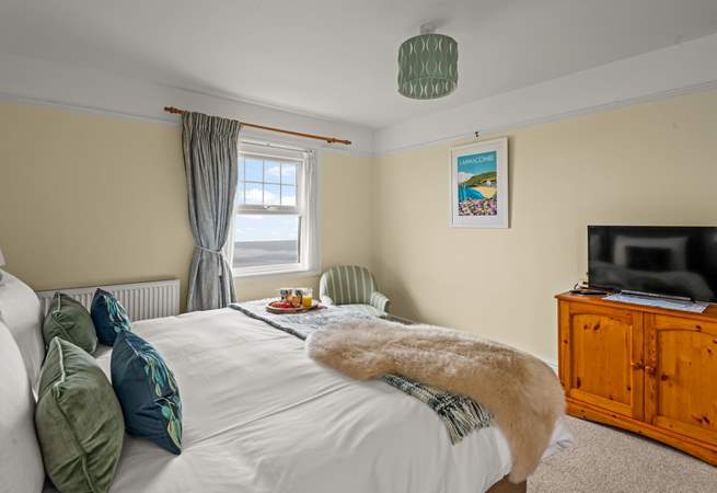Bedroom 1 enjoys sea views and a TV for those lazy mornings.