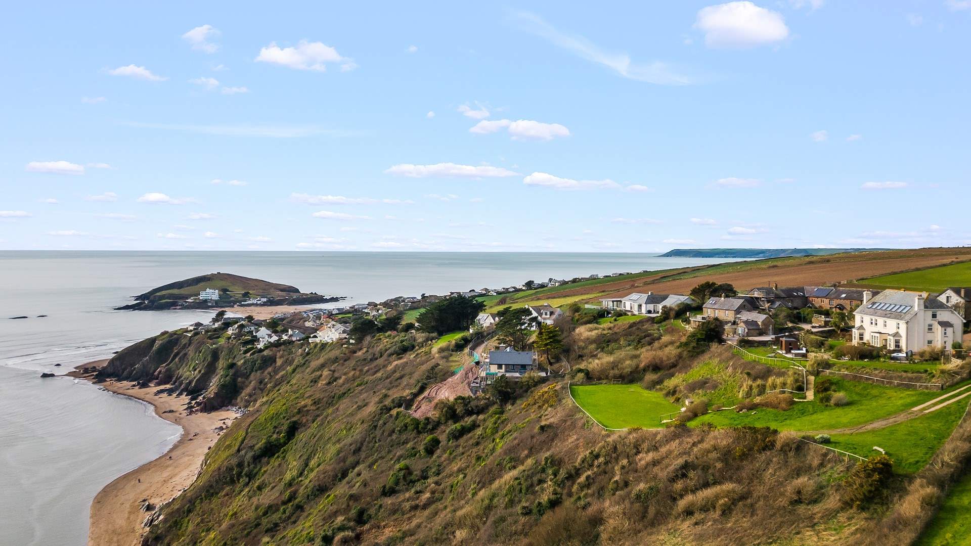 What a fabulous elevated shot, displaying Mount Folly Farmhouse to the right (white house) and Burgh Island to the left (just across the sand). You really are that close!