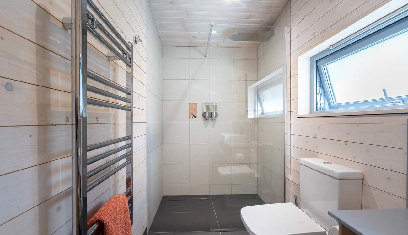The en-suite bathroom continues the sense of quiet luxury.
