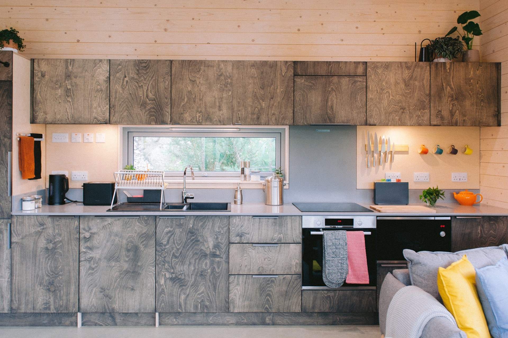 The open-plan living space unfolds effortlessly, where the beautifully sleek kitchen sits at its heart.