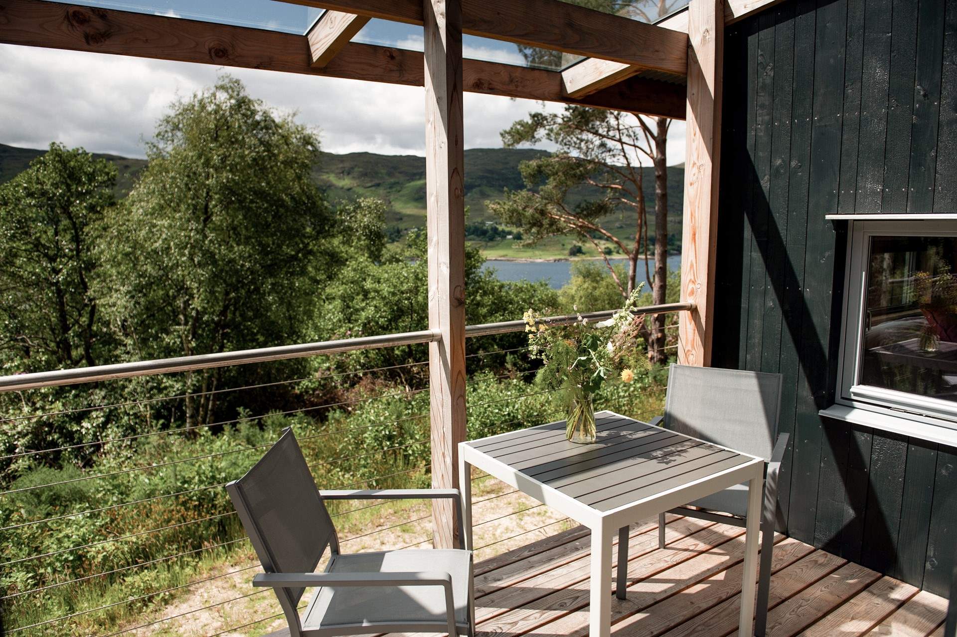 A table and chairs invite alfresco breakfasts in fresh Highland air.