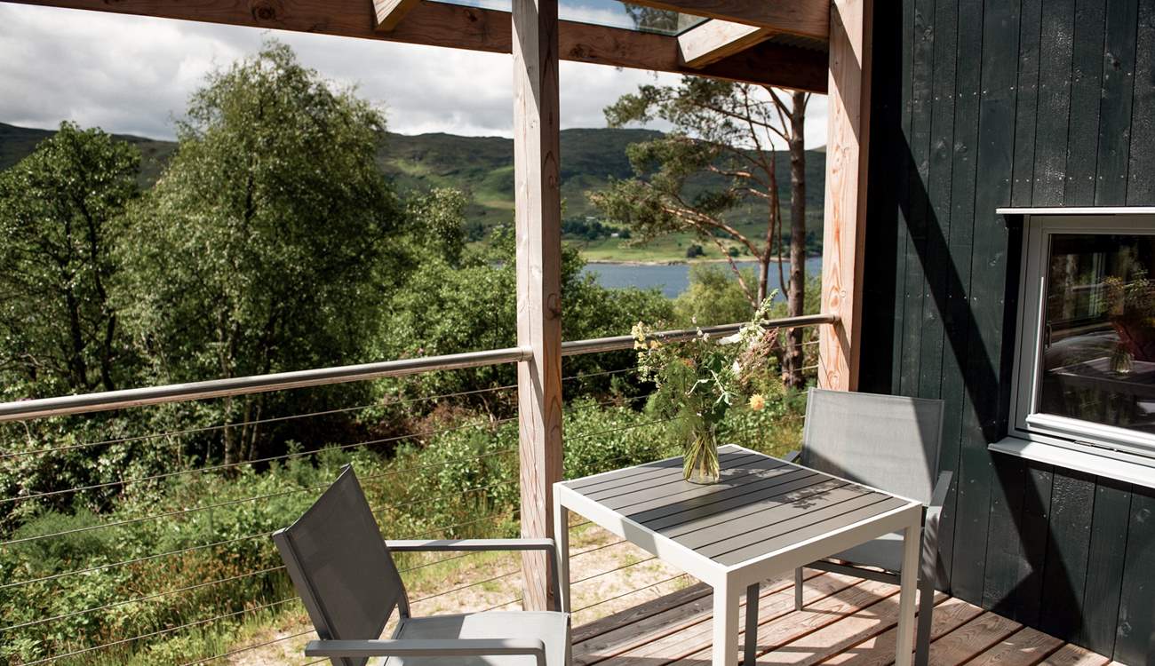 A table and chairs invite alfresco breakfasts in fresh Highland air.
