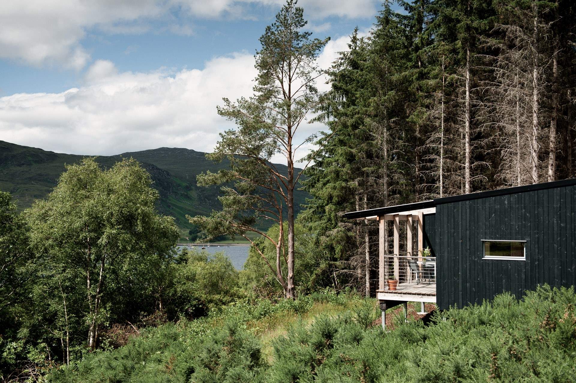 Set within a quiet woodland clearing on the shores of Loch Broom.