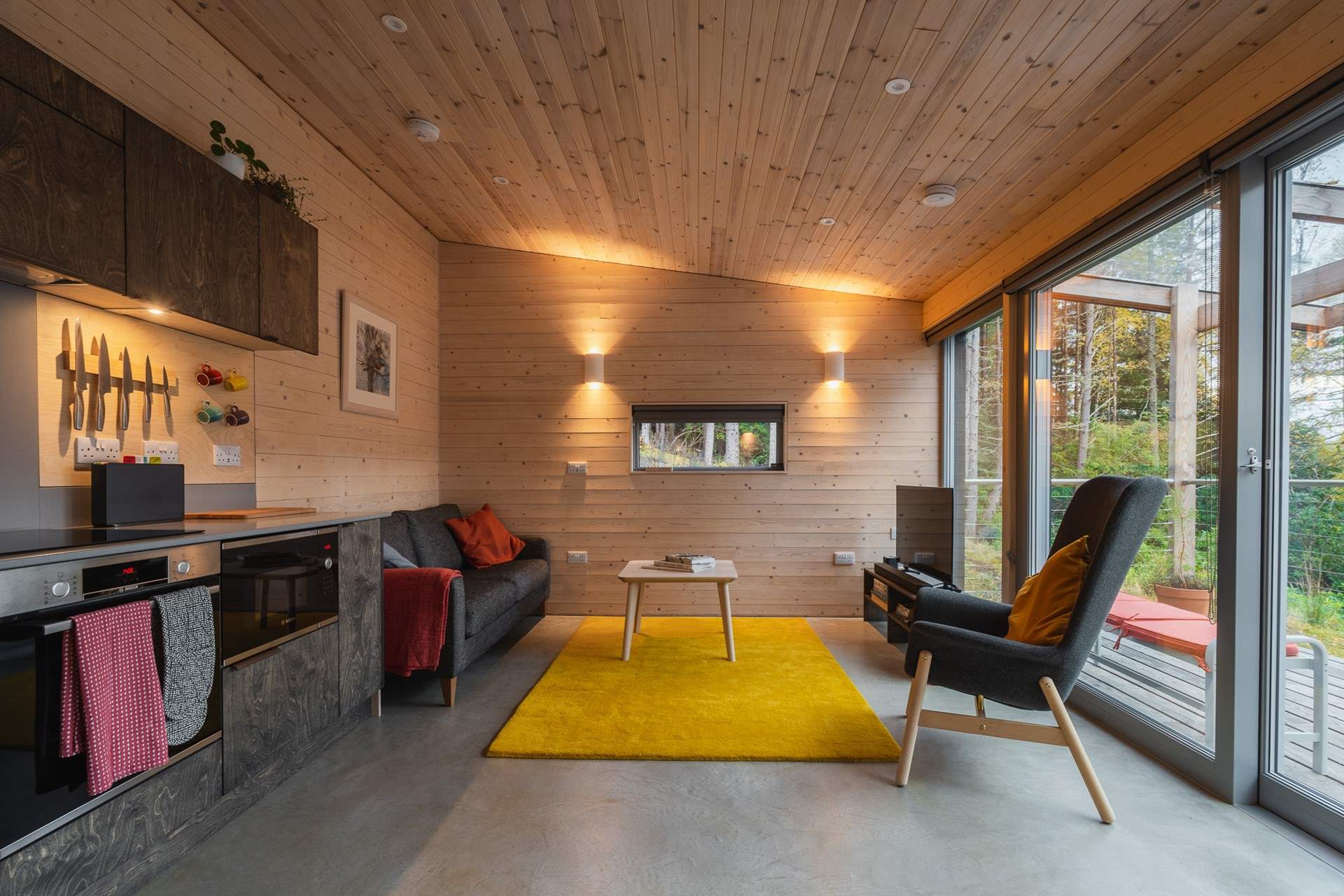 Gorgeous interiors featuring playful pops of colour and warm wood-clad walls.