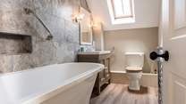 The en suite is tastefully appointed with a deep claw-foot bath and shower over.