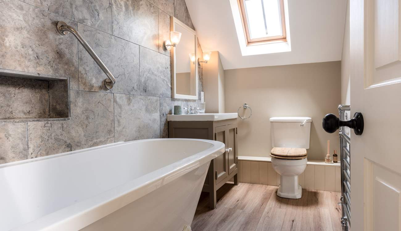 The en suite is tastefully appointed with a deep claw-foot bath and shower over.