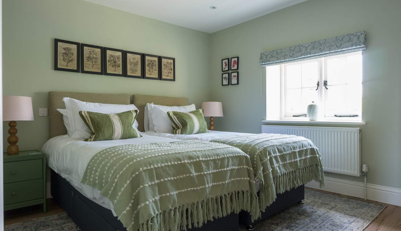 Bedroom 3 is serene and wonderfully spacious. It features large luxury single beds and lovely views out.