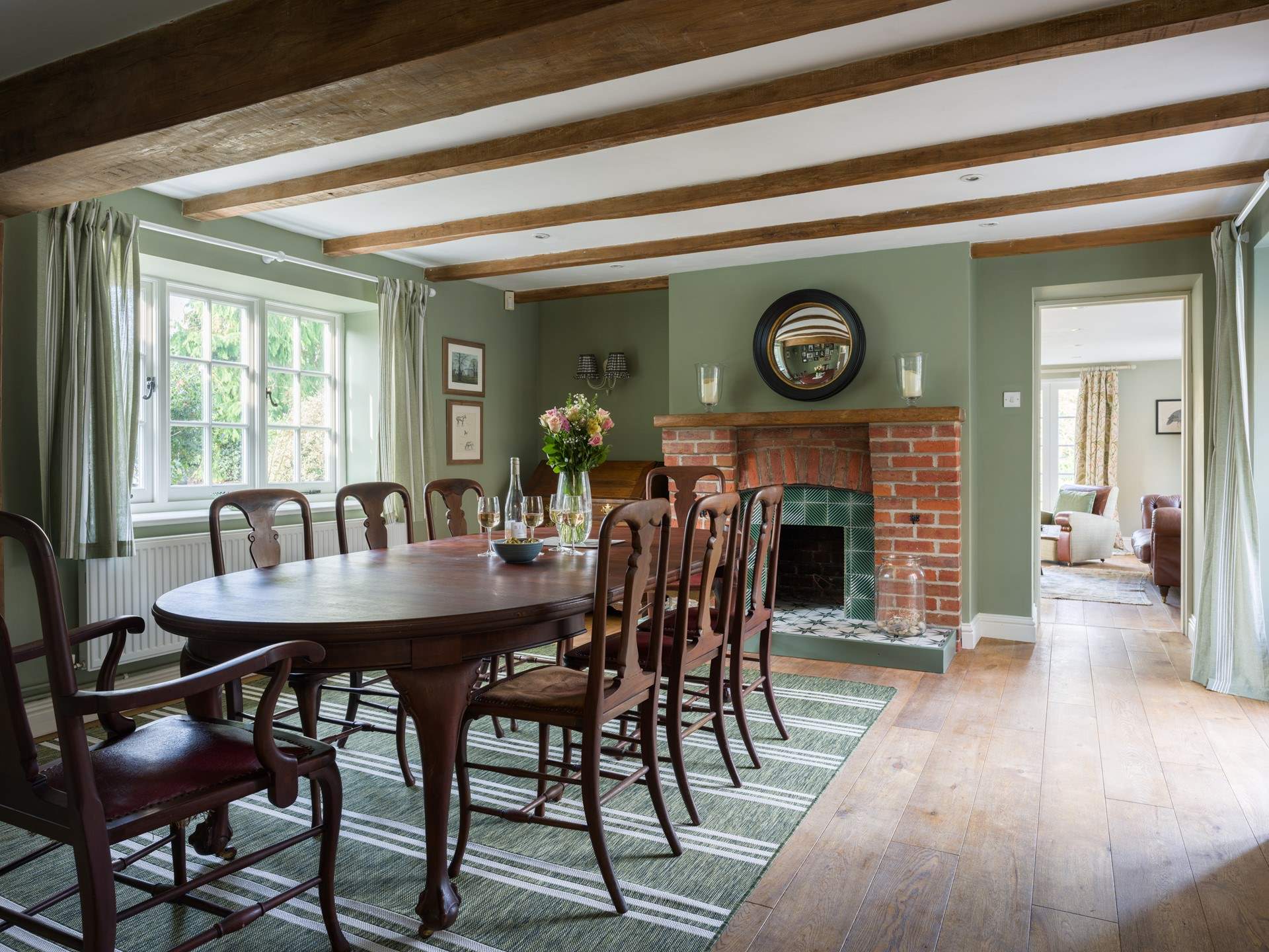 The striking dining-room is set for eight and it's dual-aspect provides the most wonderful light and atmospheric room.