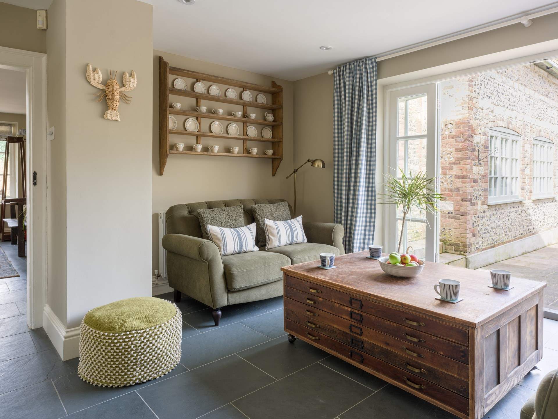 This lovely little nook at the end of the kitchen has comfy seating and is the perfect spot for a morning coffee with the doors open to the garden.